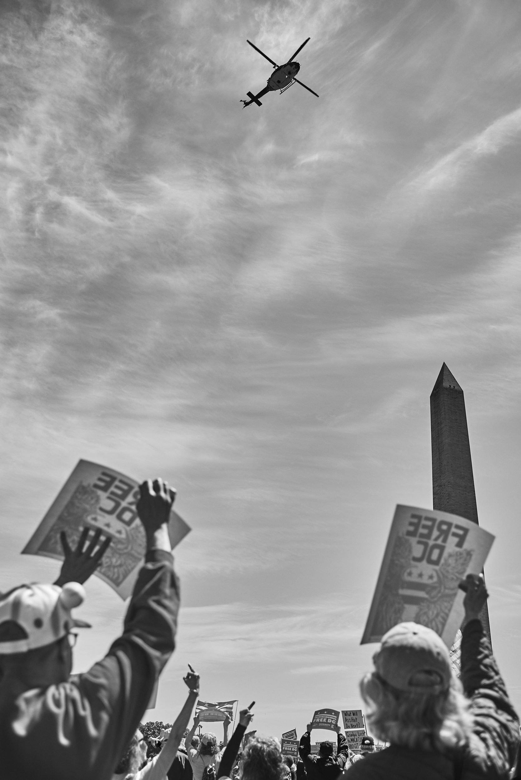 A group of protestors at the Washington Monument, flip the bird to Park Police