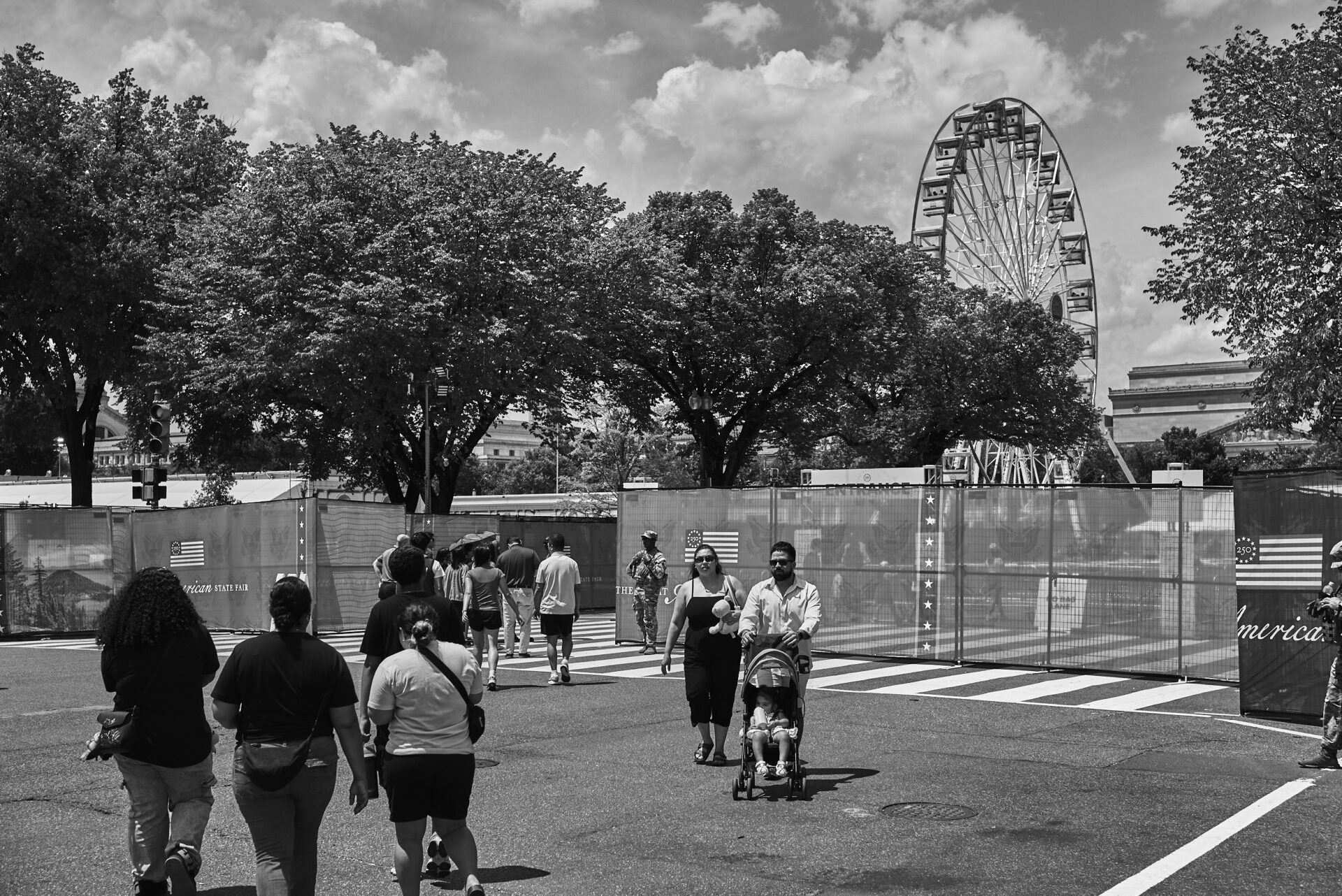 A ferris wheel looms in the background at the Great American State Fair, and national guardsmen stationed at the entrance