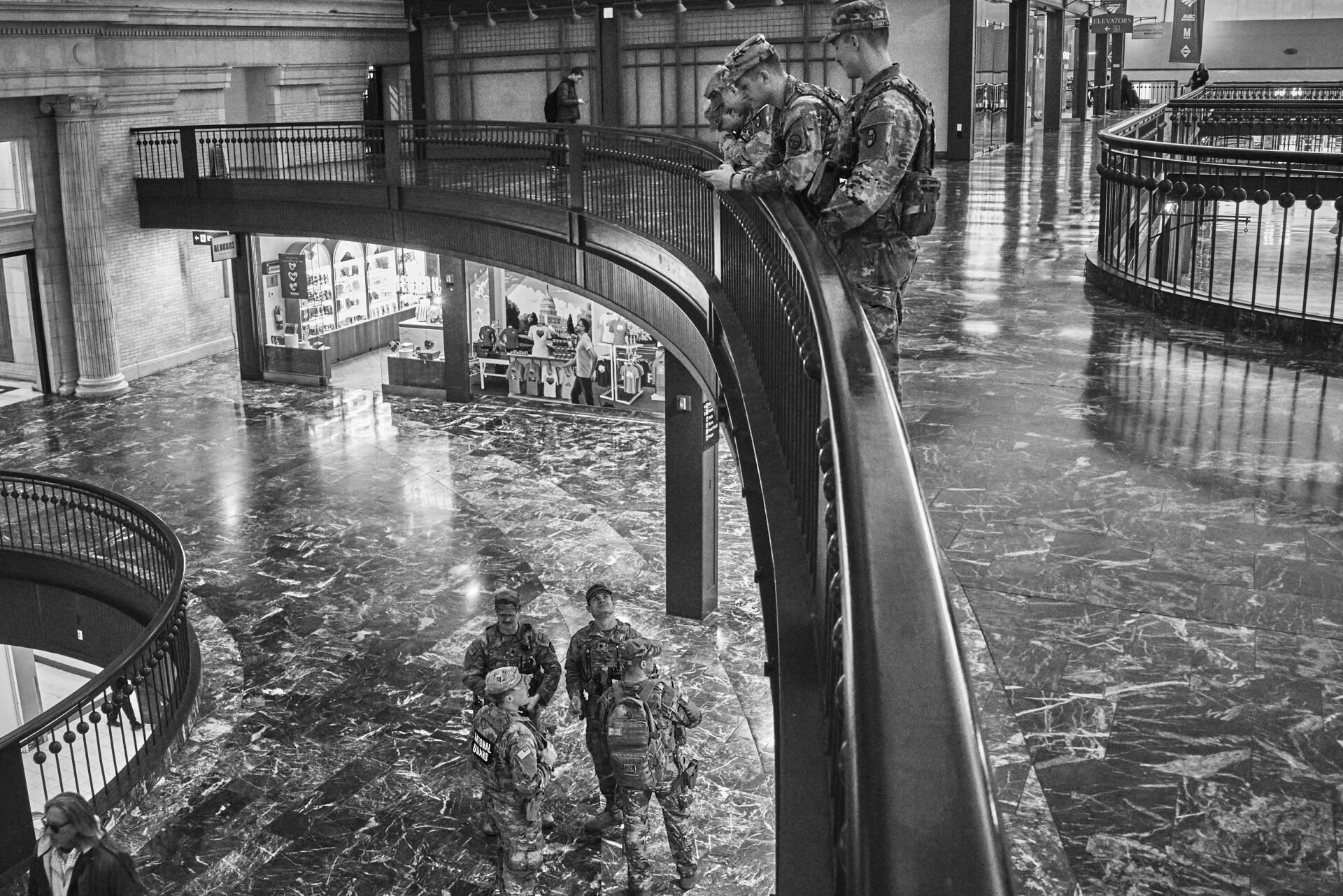 One squad of national guardsmen chats down the balcony to another squad at Union Station
