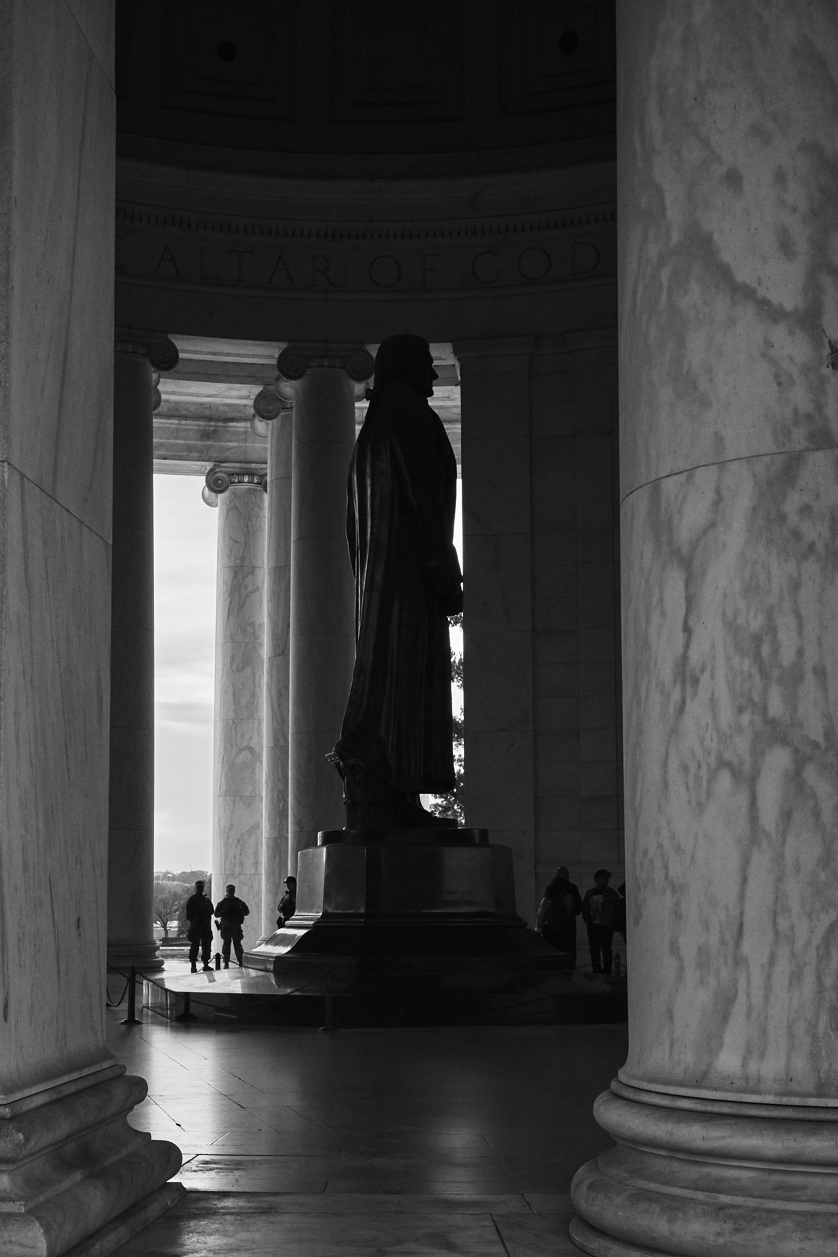 The silhouette of national guardsmen standing next to the Jefferson Memorial