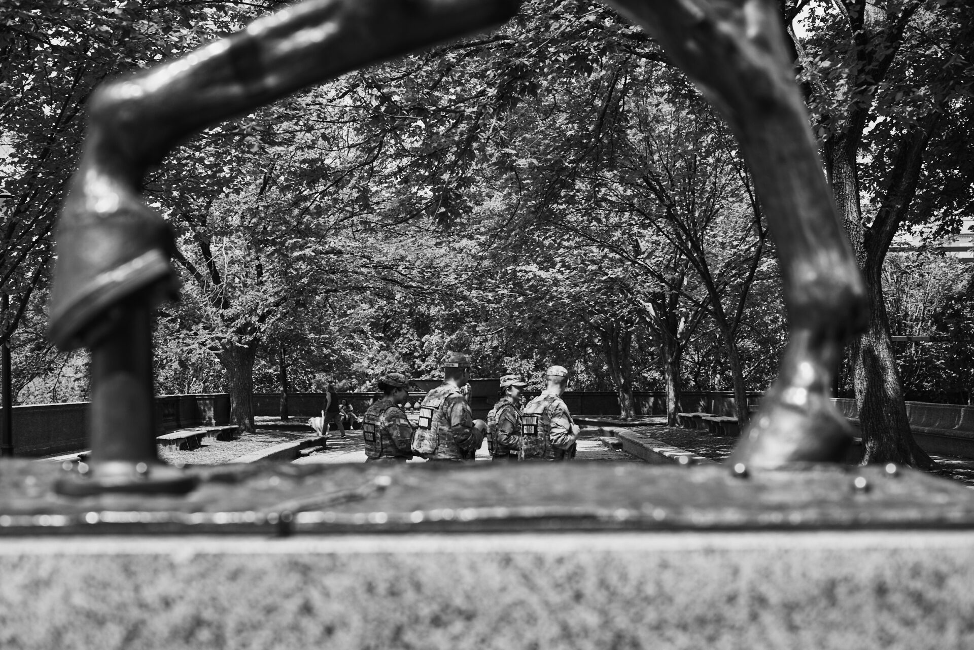 The national guard through legs of a horse statue at Malcolm X Park