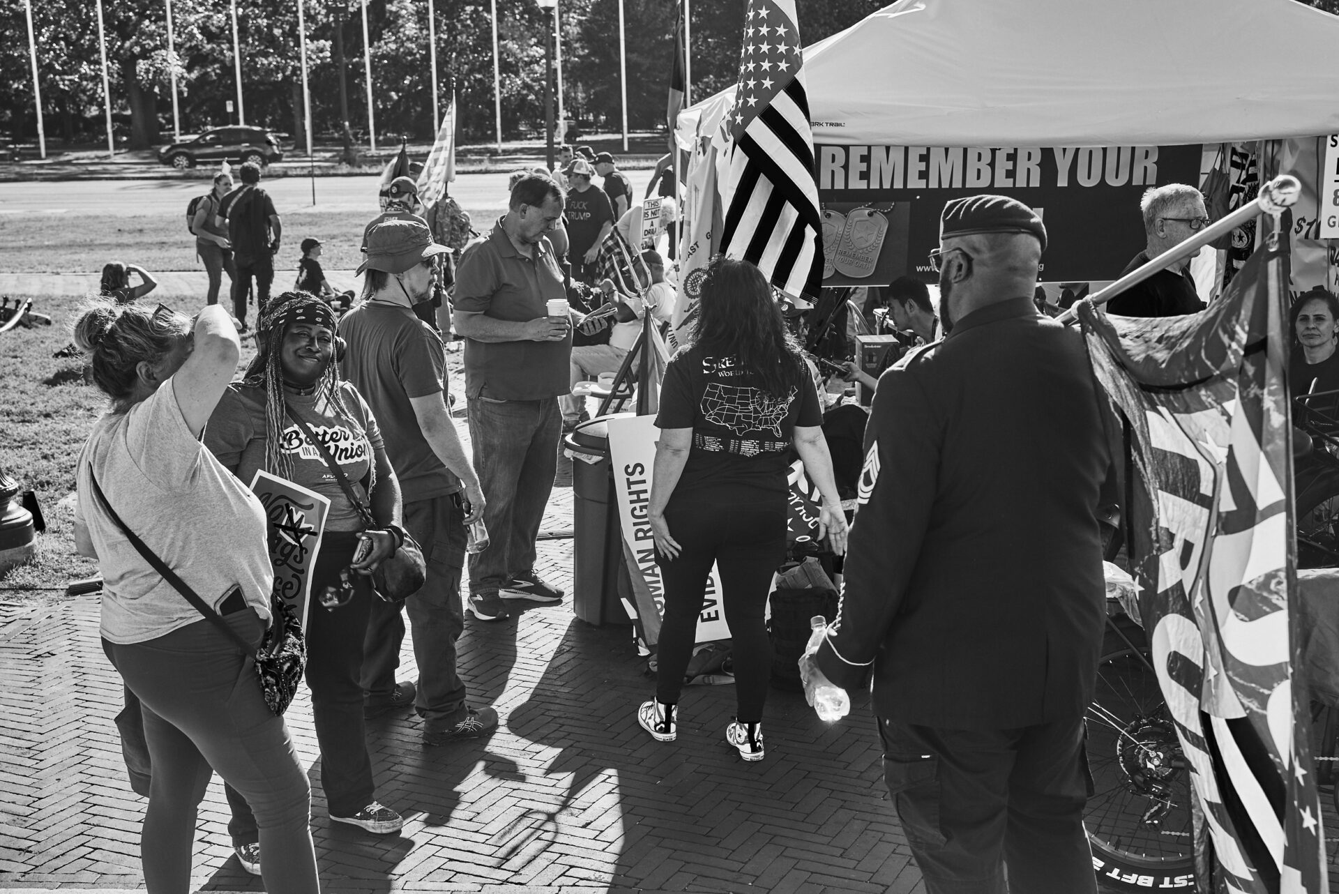 A large group of people animatedly talking at the Remember Your Oath tent